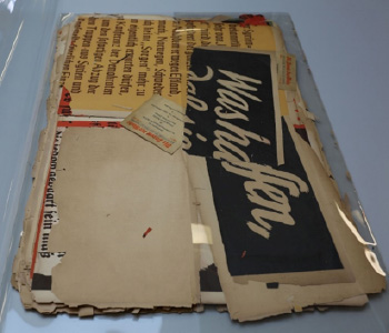 German propaganda posters A pile of old posters in a clear protective cover - they are pale background with glimpses of black text
