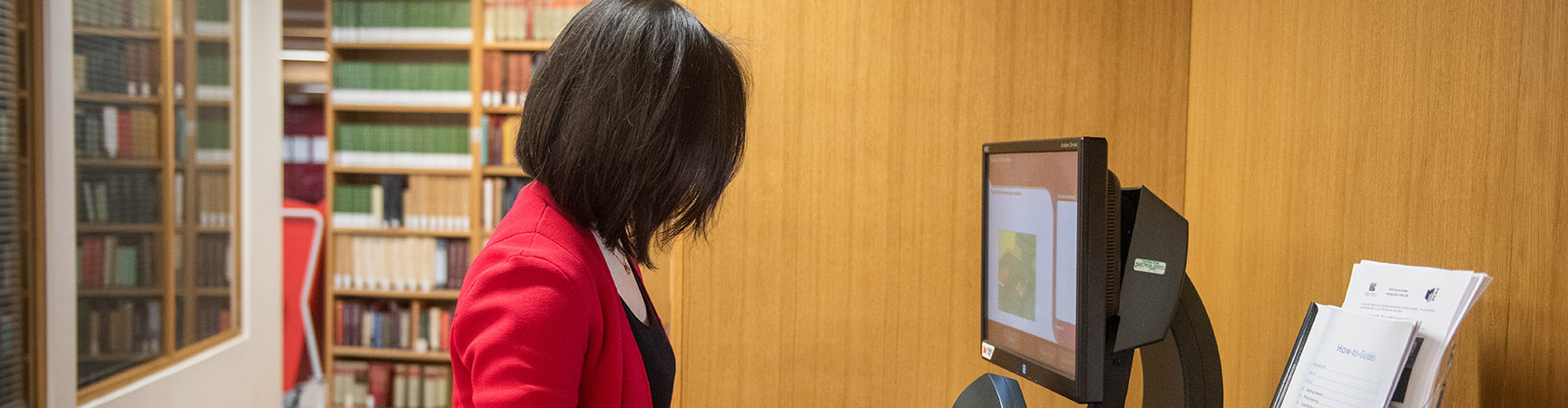 A woman looks at a computer screen