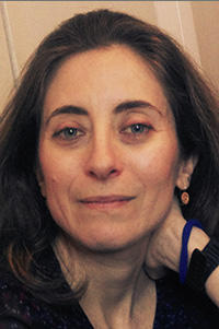 Marinita Stiglitz A portrait photograph of a woman with long brown hair - she looks directly at the camera
